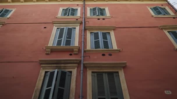 Handheld shot left to right of coloured european walls and windows — Stock Video