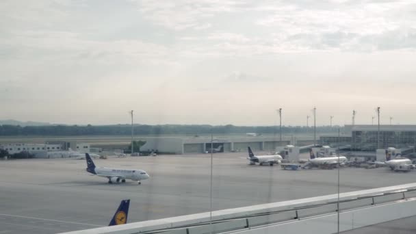 Münih, Almanya - Temmuz 2019: Münih 'teki havaalanının camından uçakların Pan atışı — Stok video