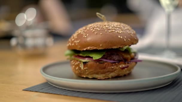 Gimbal pan shot kiri ke kanan dari burger segar di piring — Stok Video