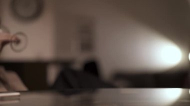 Woman hand putting a glass of white wine on the table