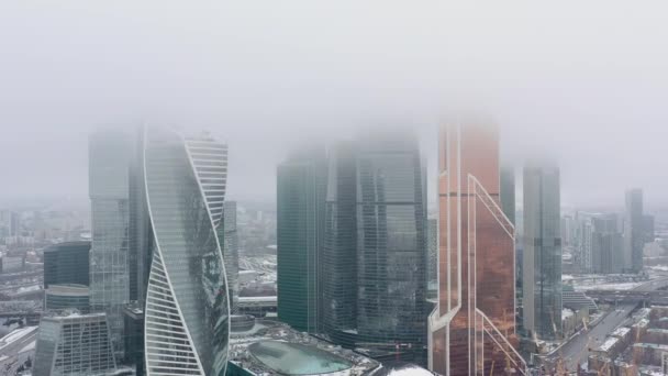 Aerial drone shot of Moscow city skyscrapers at cloudy fogy winter day — Wideo stockowe