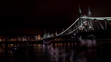 Pan shot left to right of Liberty bridge in Budapest at night time