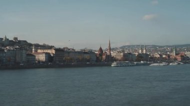 Pan shot left to right of Buda and river Danube in winter under blue grey sky