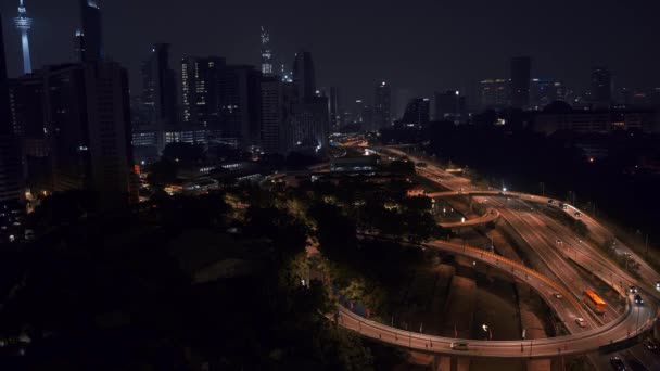 Locked down shot of modern skyline of Kuala Lumpur. Real time panorama skyline of KL downtown and traffic at night. — Stockvideo