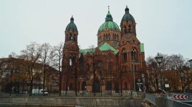 MUNICH - NOVEMBER 22: Handheld real time establishing shot of the Church of St. Luke, located on the banks of the river Isar, November 22, 2018 in Munich.