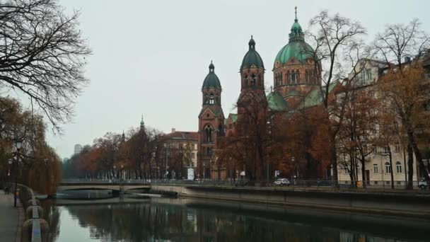 MUNICH - NOVEMBER 22: Right to left pan real time establishing shot of the Church of St. Luke, located on the banks of the river Isar, November 22, 2018 in Munich, Germany. — Stockvideo