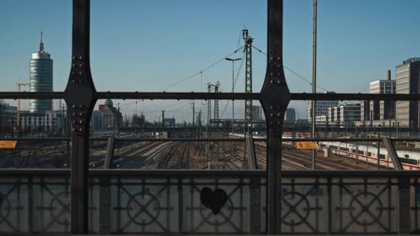 MUNICH - NOVEMBER 20: Locked down real time establishing shot of a railway taken from a road bridge in Munich. The movement of trains on the railway and cars on the road, November 20, Munich. — 비디오