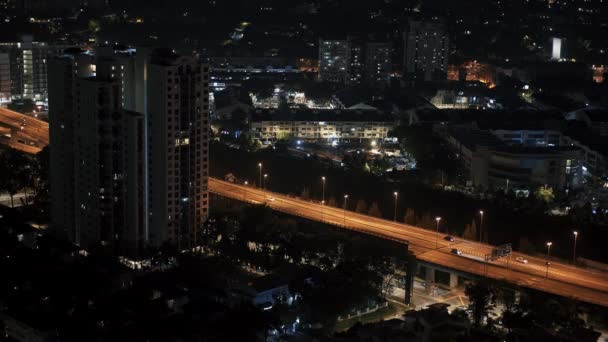 Locked down shot of modern skyline of Kuala Lumpur. Real time panorama skyline of KL downtown and traffic at night. — ストック動画