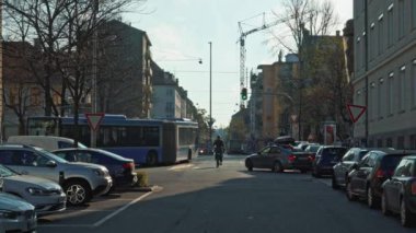 MUNICH - NOVEMBER 19: Handheld real time establishing shot of a car parking and a lively street in Munich, November 19, 2018 in Munich.
