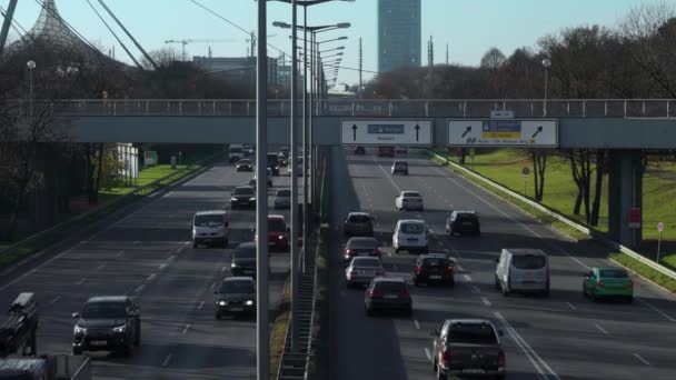 MUNICH - NOVEMBER 21: Locked down real time establishing shot of a highway near the Olympic Park in Munich, November 21, 2018 in Munich. — Stock videók