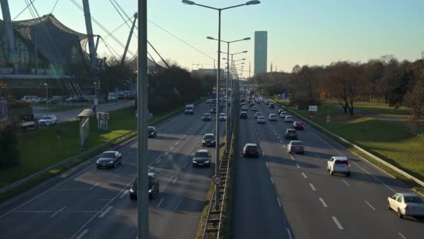MUNICH - NOVEMBER 21: Locked down real time shot of a highway near the Olympic Park in Munich. Traffic on the road, November 21, 2018 in Munich, Germany. — Stock video