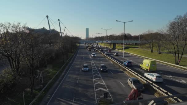 MUNICH - NOVEMBER 21: Locked down real time establishing shot of a highway near the Olympic Park in Munich, November 21, 2018 in Munich, Germany. — ストック動画