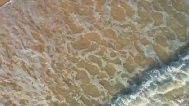 Drone shot top view over ocean waves and sand beach — Stock Video