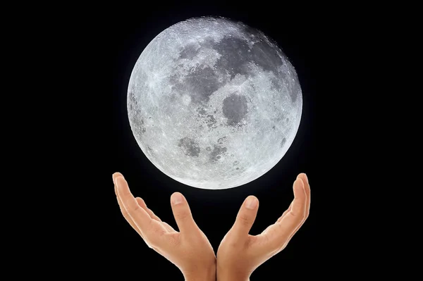 Moon in human hand, hand holding our moon. Elements of this image furnished by NASA.