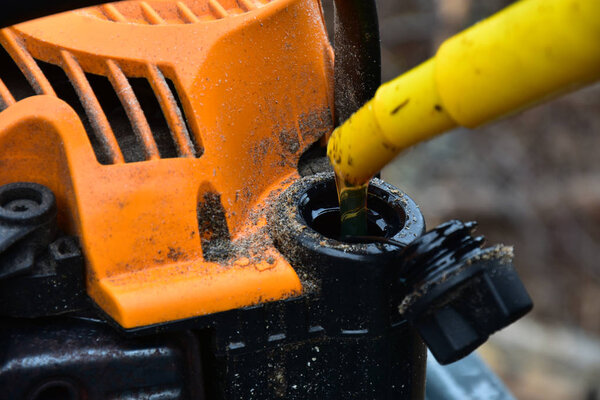 Adding Chainsaw Mix Oil