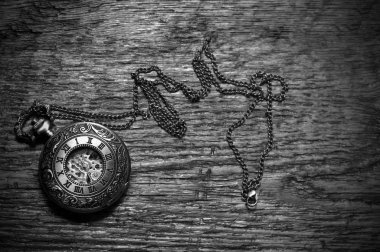 Bir antika köstekli saati üzerinde eski bir ahşap masa üstü bir üstten görünüm görüntüsü.