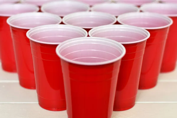 An image of red plastic cups lined up for beer pong.