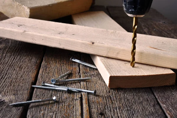A close up image of carpentry tools on an old wooden workbench.