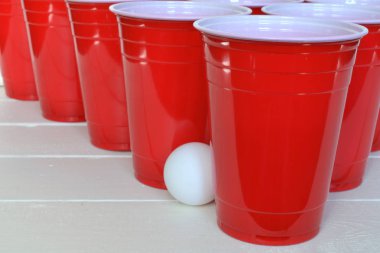 Görüntü kırmızı plastik içme bardak ve beyaz plastik ping pong topları yakından. 