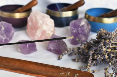 A close up image of burning incense and meditation crystals. clipart