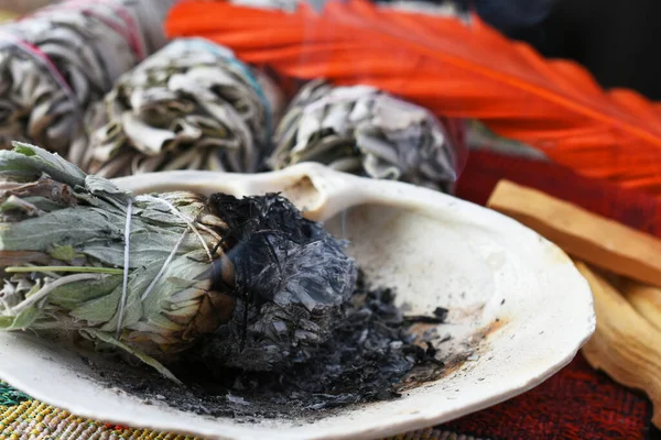 A close up image of a burning sage bundle used for energy clearing and healing.