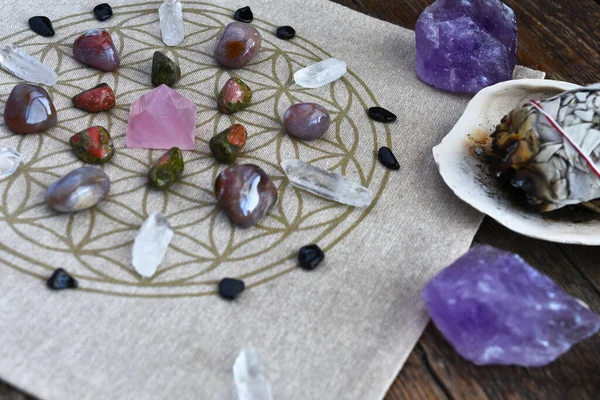 A close up image of a crystal energy healing grid using the flower of life pattern.