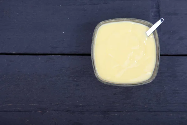 Ahşap zemin üzerine vanilya krema küçük kase