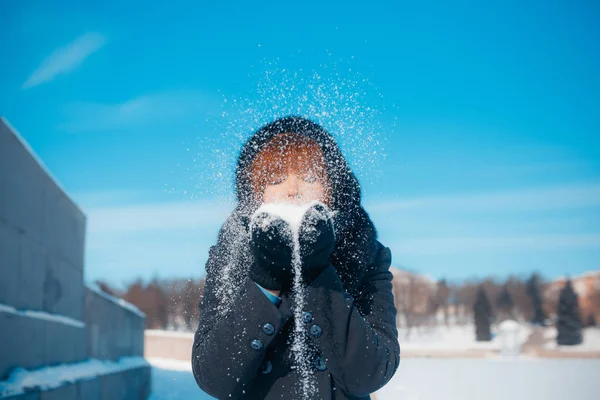 MINSK, BELARUS - February 1, 2017: red-hair woman blowing snow i — Stock Photo, Image