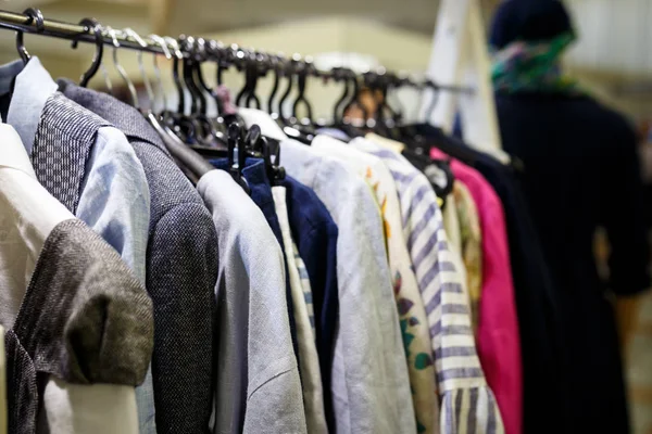 Ropa de mujer colorida cuelga de perchas en una tienda minorista. Fashi. —  Fotos de Stock