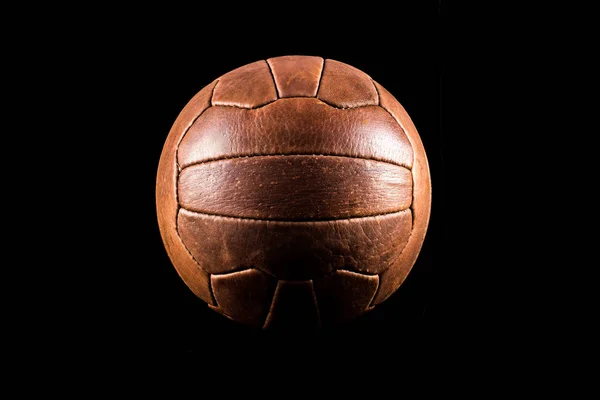 黒の背景に古いサッカー革ボール — ストック写真