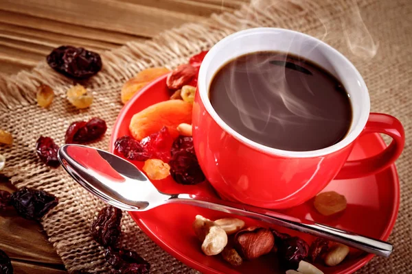 Red ceramic cup with hot coffee on wooden boards. — Stock Photo, Image