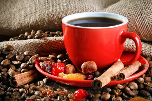 Red ceramic cup with hot coffee on wooden boards. — Stock Photo, Image