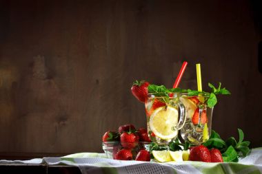 Fresh summer healthy drink with lemon and strawberries with ice. clipart