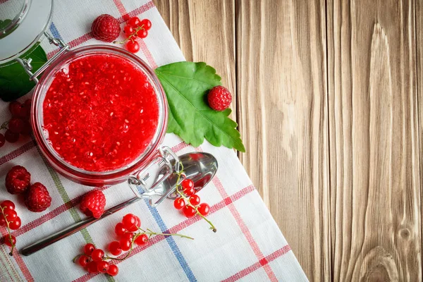 Ripe raspberry and raspberry jam on a wooden table. — Stock Photo, Image