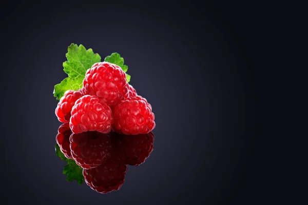 Fresh organic ripe raspberries on a black background. — Stock Photo, Image