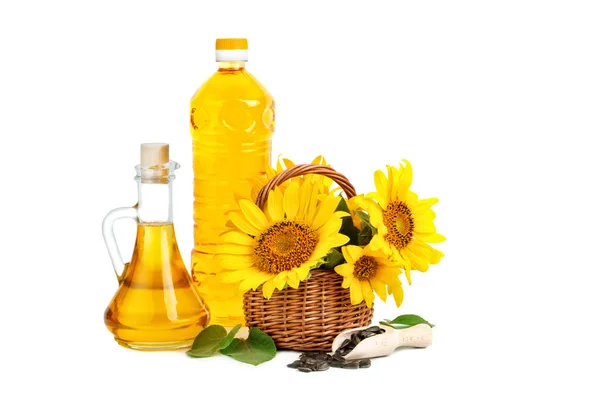 Beautiful flowers of sunflowers in a rustic basket and sunflower oil on a white background. — Stock Photo, Image
