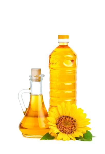 Hermosos girasoles y aceite de girasol sobre un fondo blanco . —  Fotos de Stock