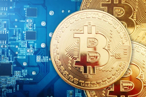 Üç Altın bitcoin ekran kartı üzerinde yalan.