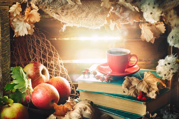 Autumn still life with a cup of coffee, apples and autumn leaves. Autumn background.