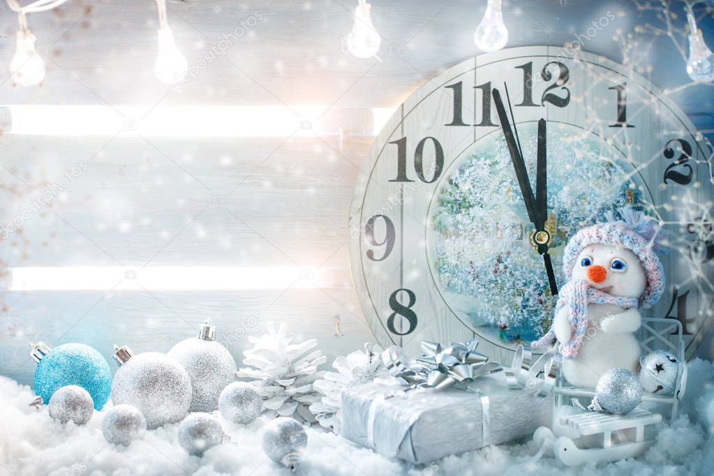 Christmas winter a background, the small snowman stands with a clock. Happy New Year. Merry Christmas.