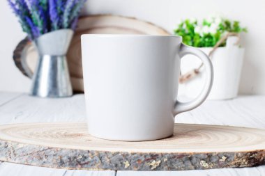 White mug on a background of flowers . Mock up. Template Space for creative artwork. Lettering text product promotion branding.