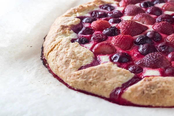 Berry Tart. Galette with summer berries. Pie with strawberry and cherry