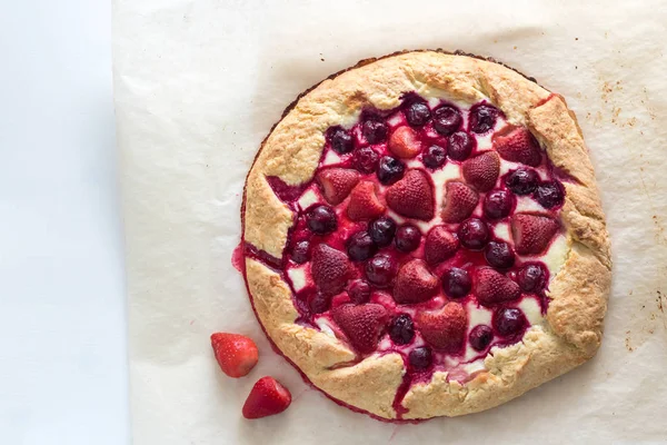 Berry Tart. Galette with summer berries. Pie with strawberry and cherry