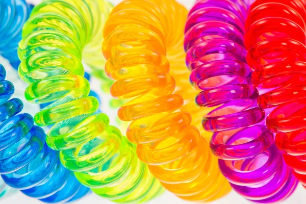 Abstract background of various spiral hair ties — Stock Photo, Image