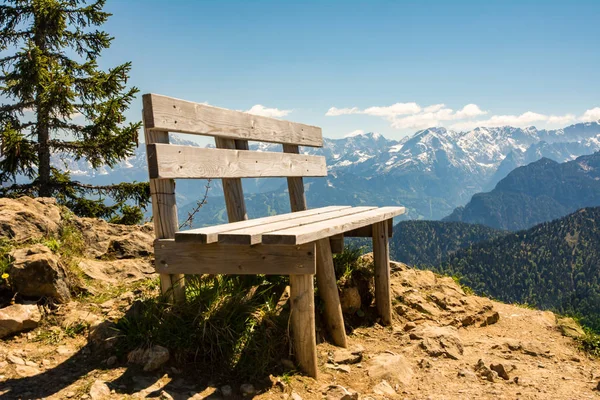 Empty wooden bench in the bavarian alps — Stock Photo, Image