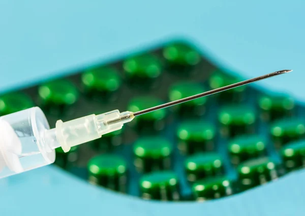 Injekční stříkačka a blistr s tabletami — Stock fotografie