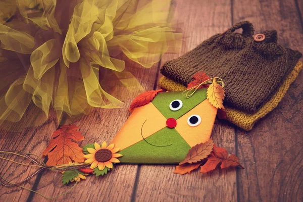 Toy kite, autumn leaves, tulle and knitted baby clothes — Stock Photo, Image