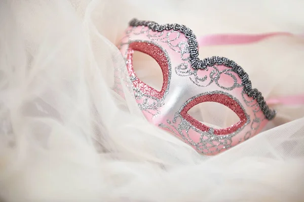 Beautiful Italian carnival mask on white tulle