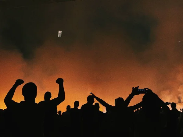 Crowd of people at stadium in smoke