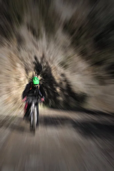 Motociclista andando de bicicleta em um caminho de montanha — Fotografia de Stock